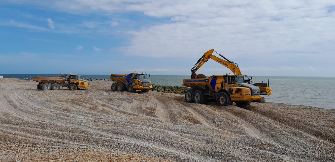 An image of beach management taking place along the coast.