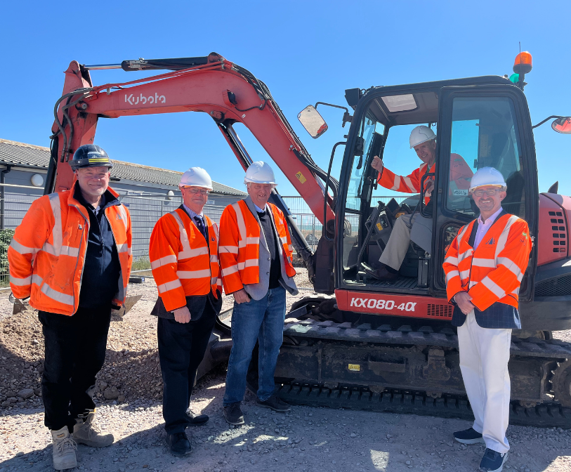 A photograph of Cllrs Paul Thomas, Jeremy Speakman, Jim Martin and David Wimble with Paul McLean of Walker Construction on site.