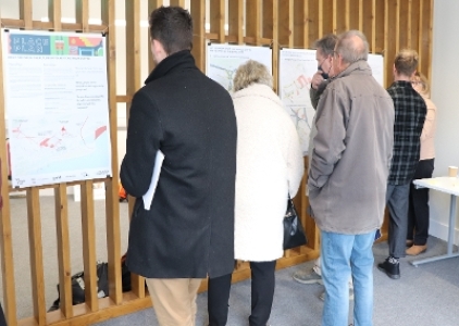 Image showing a group of people looking at a variety of posters duiring Engagement event at Bouverie Business Centre.