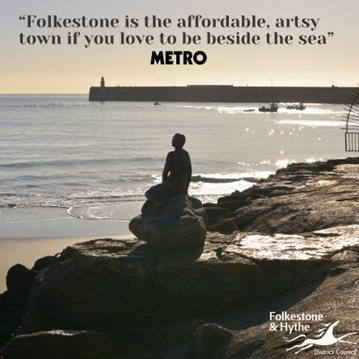 This is a picture of a Mermaid statue sitting on a rock look out over the harbour