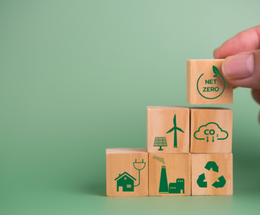 Blocks with renewable energy logos stacked on a green background
