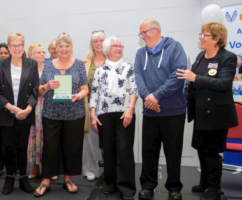 An image of recipients being given an award at a previous volunteers recognition event