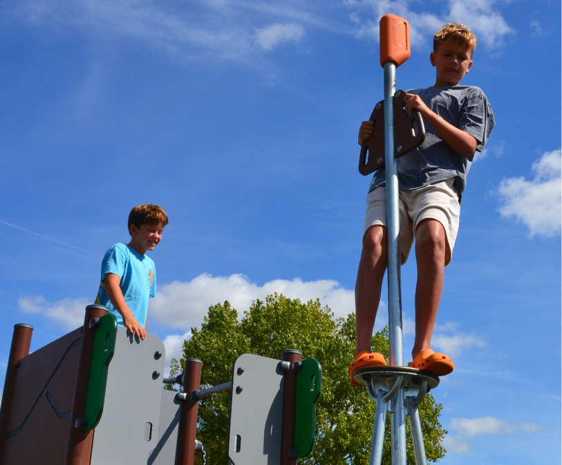 Two children enjoying a new piece of equipment at Cheriton Recreation Ground