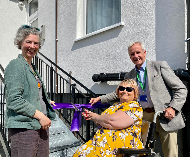Elaine Cox cutting the ribbon to officially open Ross House alongside Cllr Shoob and Cllr J Martin