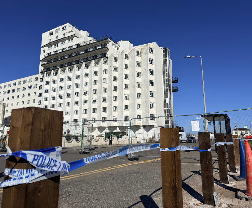 A photograph showing the Grand Burstin hotel behind police line tape and heras fencing following a fire this weekend.
