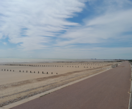 Photograph shows empty beach at St Mary's Bay with sea in the distance.