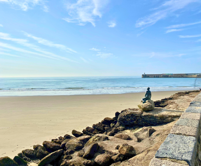 An image of the mermaid statue at Sunny Sands on a sunny day